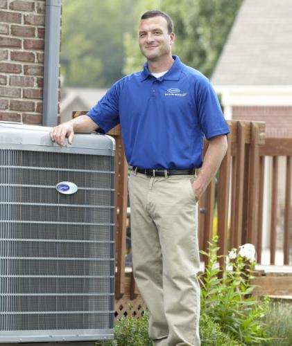 Technician in front of A/C unit